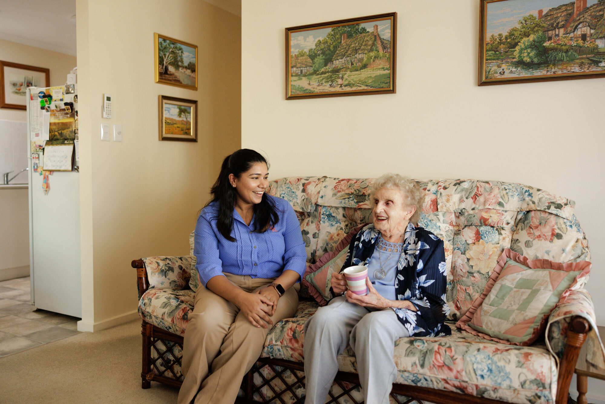 A care home manager chatting warmly with a resident.