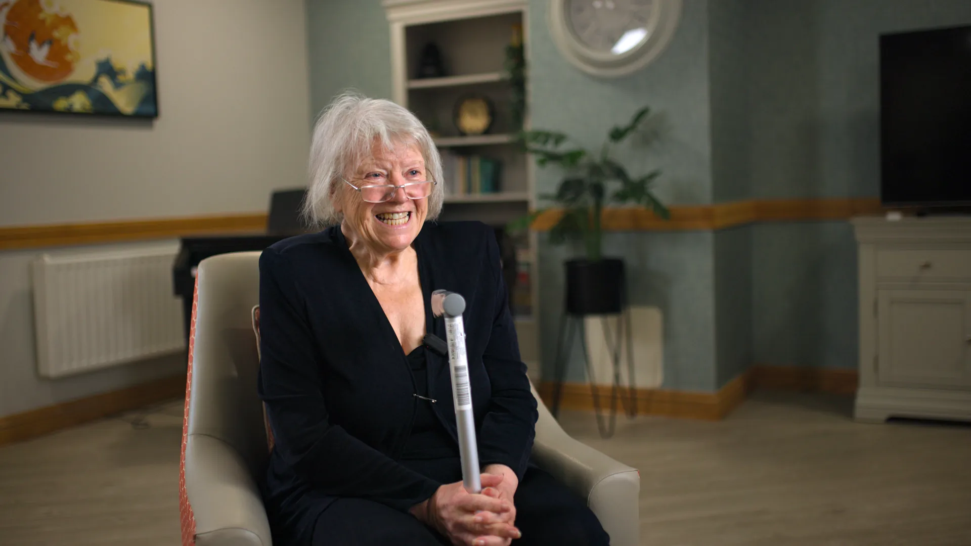 A resident laughing during an interview in the lounge.